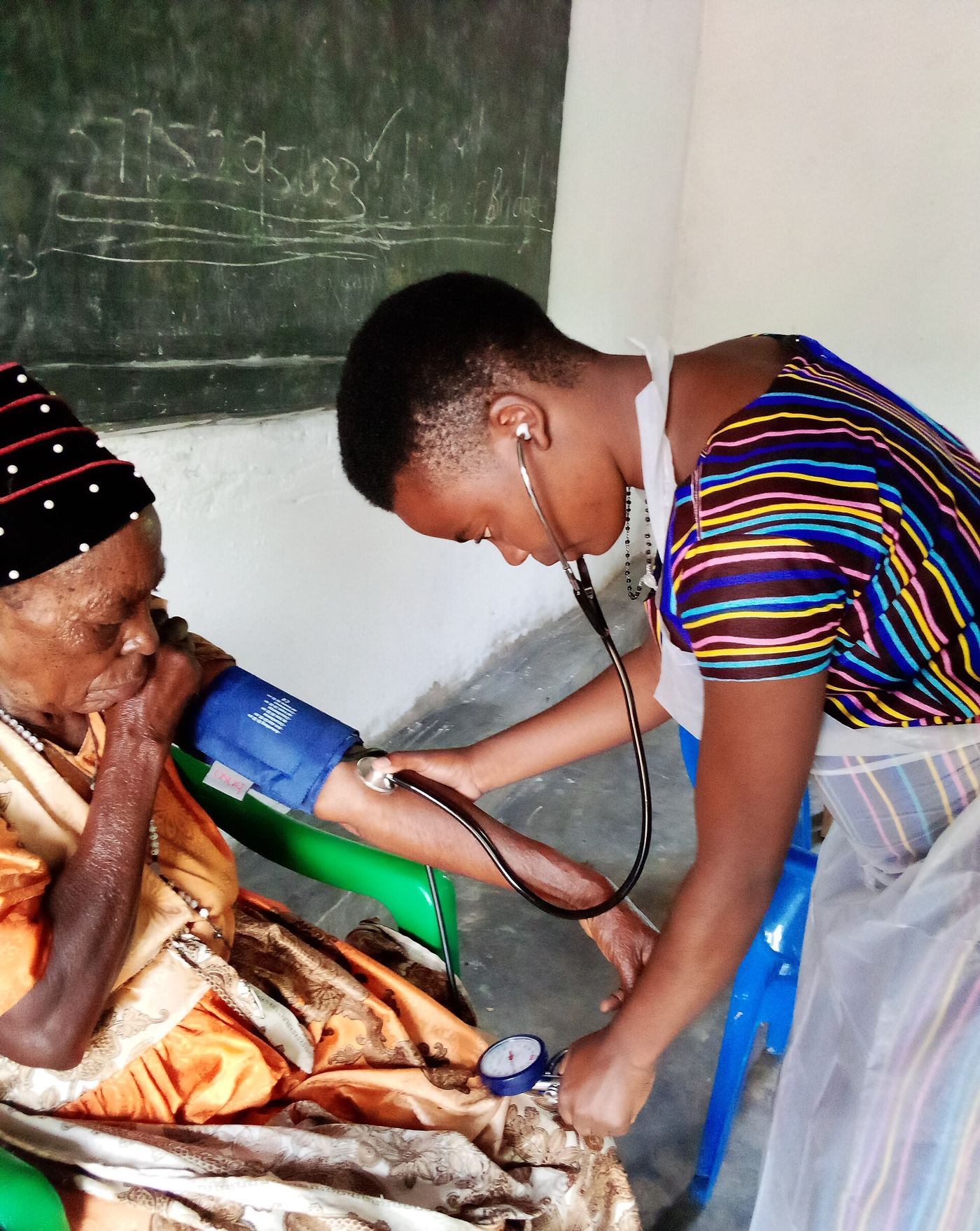 nurse measuring patient blood pressure in clinic